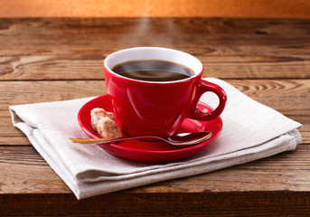 Coffee cup and saucer on  wooden table.
