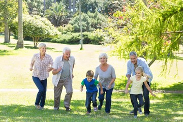 Happy family running in the park