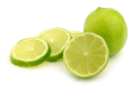 fresh lime fruit and some thin slices on a white background