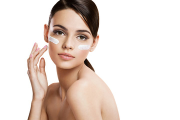 Skin care woman putting face cream