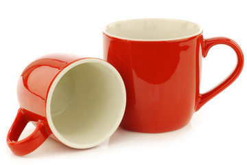 new red mugs on a white background