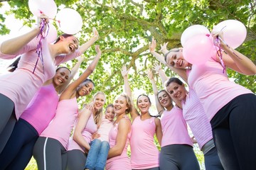 Smiling women in pink for breast cancer awareness
