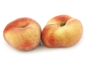 Fresh wild (flat) nectarines on a white background