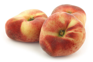 Fresh wild (flat) nectarines on a white background