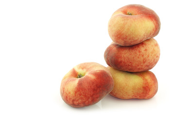 Fresh wild (flat) nectarines on a white background