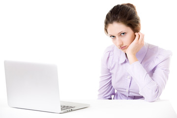 Young woman not in the mood for work in front of laptop