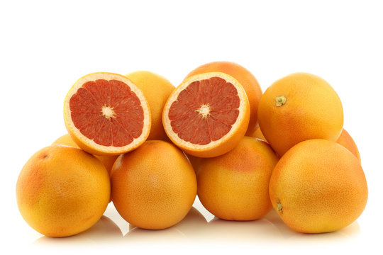 bunch of red grapefruits on a white background