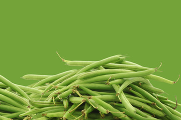 Green beans on a green background with copy space
