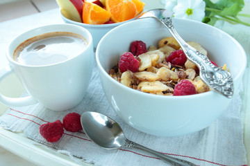 Bowl with cereals and berries with cup of coffee