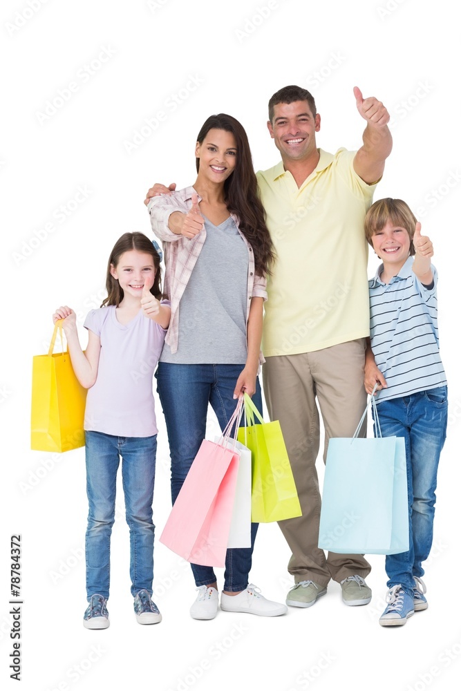 Wall mural Family with shopping bags gesturing thumbs up