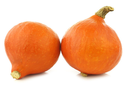 Two orange pumpkins on a white background