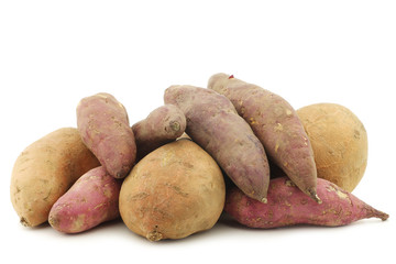 two whole sweet potatoes on a white background