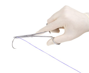 Surgical needle in the hands of the surgeon
