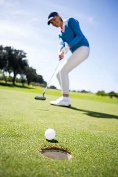 Female golfer putting her ball