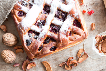 cherry pie on a wooden kitchen table