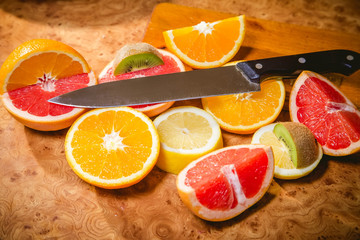 Fototapeta na wymiar Fruit salad, sliced fruit, kiwi, orange, lemon, grapefruit