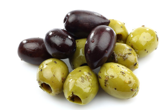 bunch of black and seasoned green olives on a white background
