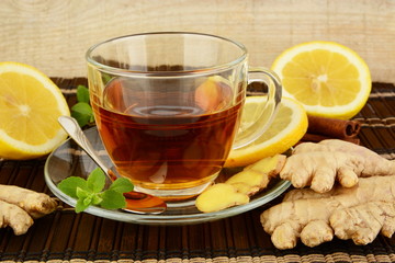 Ginger tea-ingwertee on brown mat with lemon