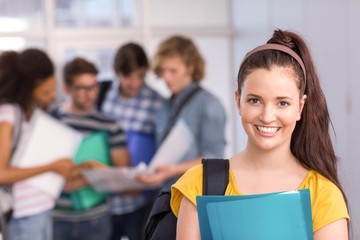 Female student holding folder in college