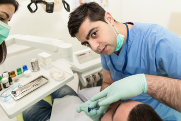 Dentist Doing A Dental Treatment On Patient