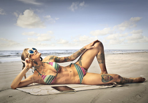 Tattooed girl at the seaside