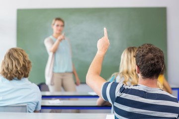 Student raising hand in classroom
