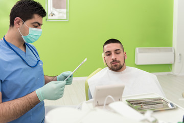 Dentist Writes On The Card Patient Personal Information