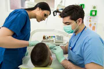 Dentist Doing A Dental Treatment On Patient