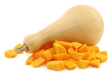 bottle shaped butternut pumpkin and some cut blocks on a white b