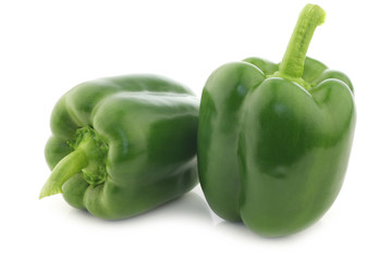 fresh green bell peppers (capsicum) on a white background