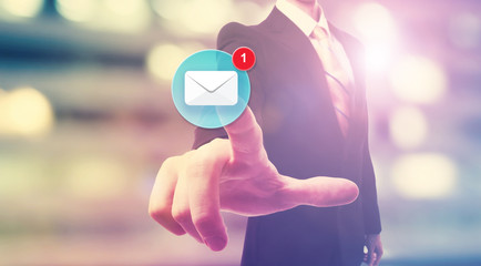 Businessman pointing at email icon © Tierney