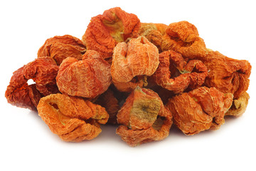 bunch of dried red bell peppers on a white background