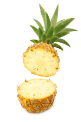 cut mini pineapple fruit on a white background