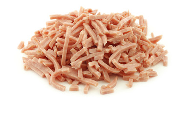julienne cut ham on a white background
