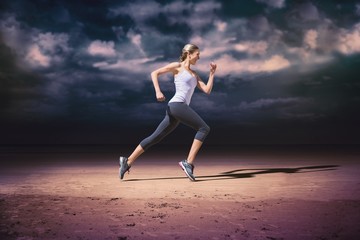 Obraz premium Composite image of pretty fit blonde jogging