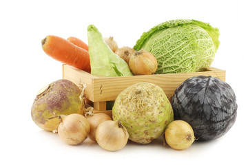collection of many fresh winter vegetables in a wooden crate on 