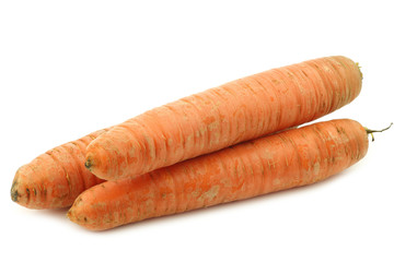 three winter carrots on a white background