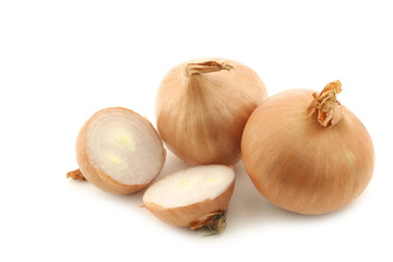 Fototapeta premium two shallots and a cut one on a white background