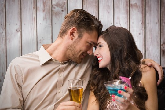 Composite image of cute couple drinking