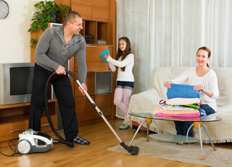Girl with parents cleaning at home