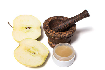 Wooden pounder with bottles of organic cream isolated