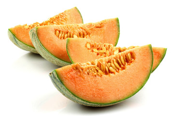 pieces of cantaloupe melon on a white background