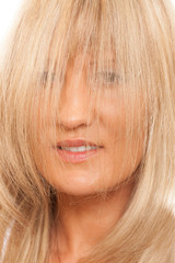  Woman covering her face with long straight hair.