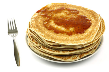 a plate with stacked freshly baked pancakes with a fork