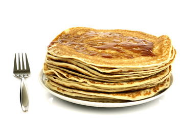 a plate with stacked freshly baked pancakes with a fork
