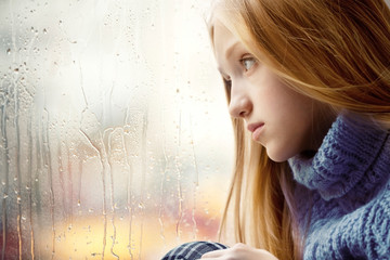 Rainy Day: Girl looking through the Window - obrazy, fototapety, plakaty