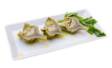 Boiled artichokes on tray on white background