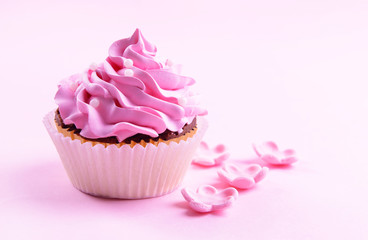 Delicious cupcake on pink background