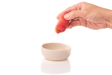 Tuna Nigiri sushi in hand with soya sauce on White Isolated background