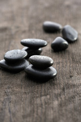Stack of black sea paddles on rustic wooden background